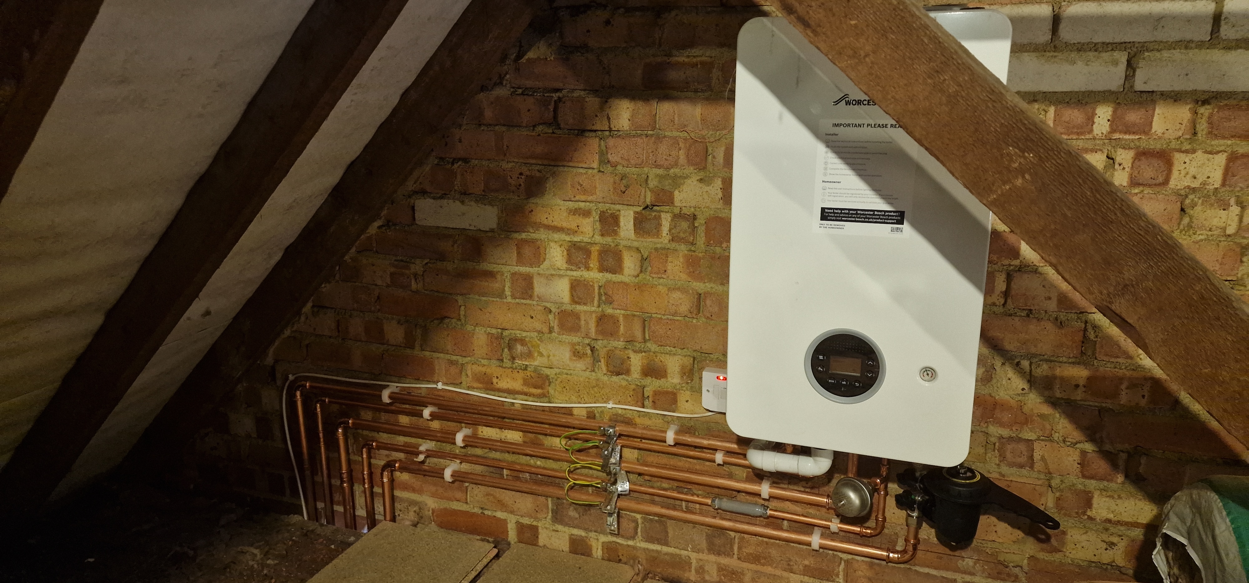A newly fitted Worcester Bosch combi boiler installed in a loft space
